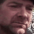 a gif of a cowboy chewing